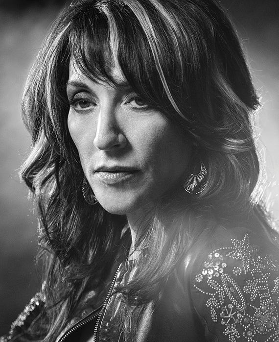 Katey Segal headshot wearing a bedazzled jacket with highlights in her hair