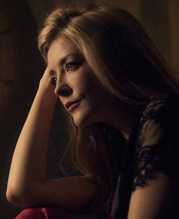 Jennifer Finnigan headshot with her arm up and hand on her head