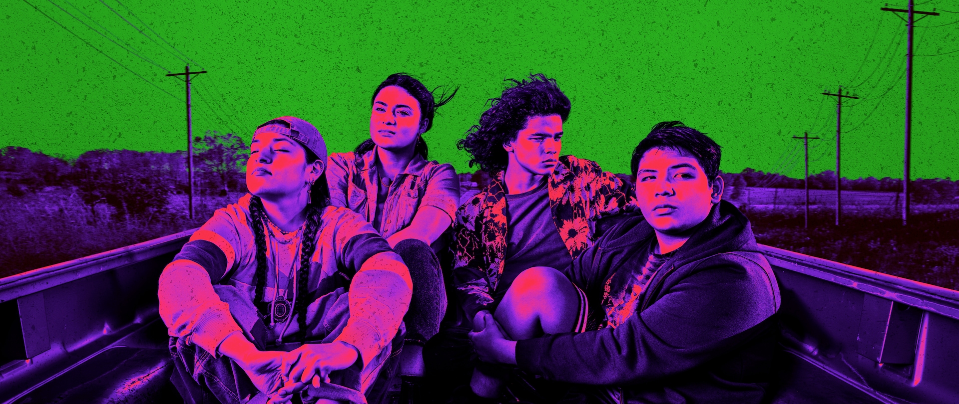 Invert color style in purple and green of Reservation Dogs cast sitting in the bed of a truck on a rural highway.