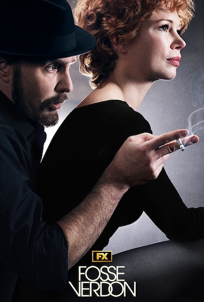 Bob Fosse wearing a black shirt and fedora hat holding a cigarette next to dancer Gwen Verdon wearing a black leotard
