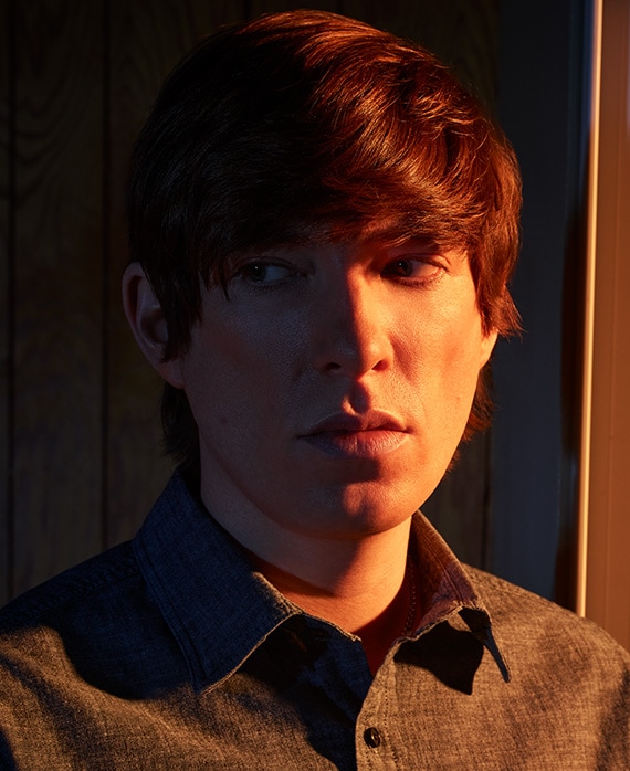 Domhnall Gleeson headshot wearing a gray button up shirt