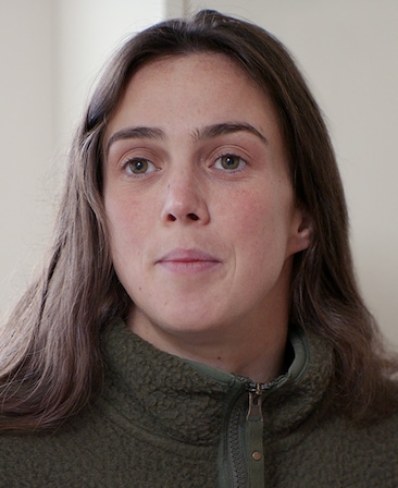 Rosie Hughes headshot wearing a green zip up sherpa jacket