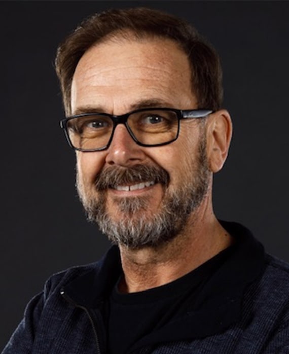 Chris Long headshot wearing black sunglasses and black shirt