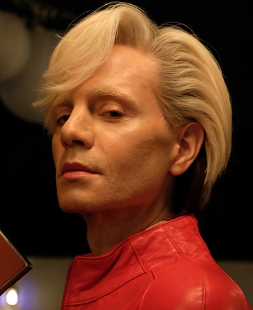 FX's The Shards Jordan Roth as Steven Reinhardt wearing a red suede jacket with his tailored hair style.