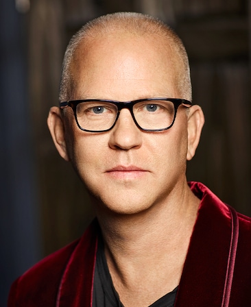 Headshot of FX's The Shards executive producer Ryan Murphy wearing a black shirt and red velvet suit.
