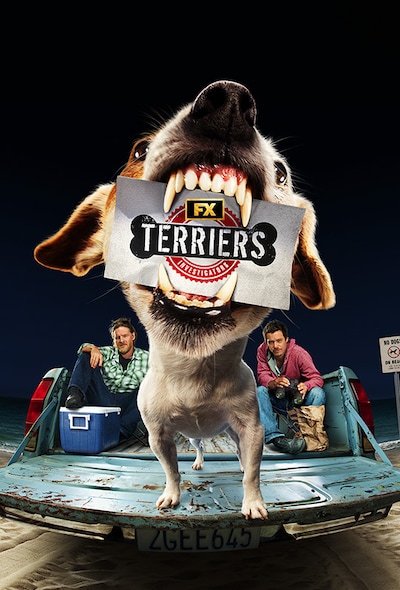 Two men sitting in back of a truck with a Chihuahua on the tailgate holding a Terriers Investigators business card in its jaw