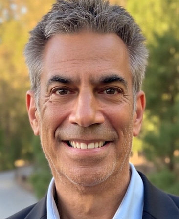 Headshot of executive producer Michael London wearing a suit and in front of trees.