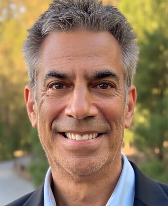 Headshot of executive producer Michael London wearing a suit and in front of trees.