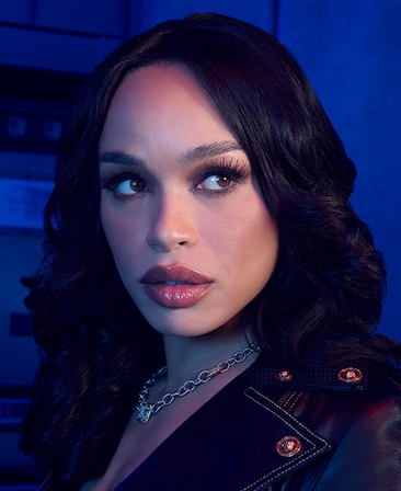 Cleopatra Coleman as V. Stiviano in FX's Clipped wearing a silver chain necklace and black leather jacket.