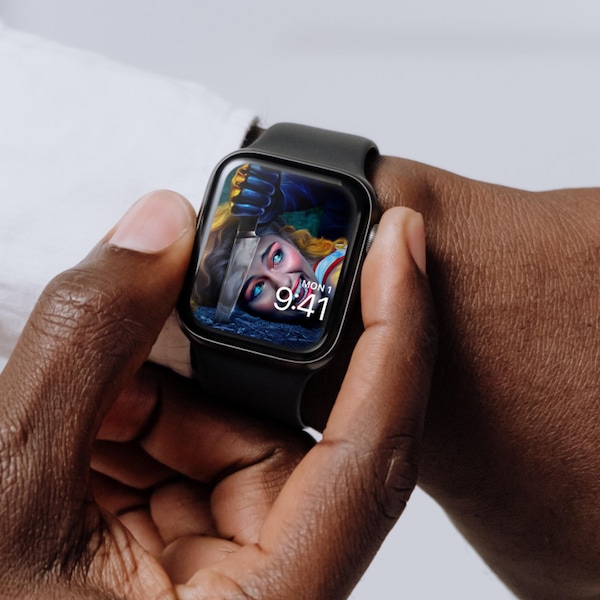 Man wearing Apple Watch with lock screen of a woman laying on the ground screaming as a hand pierces the ground next to her.