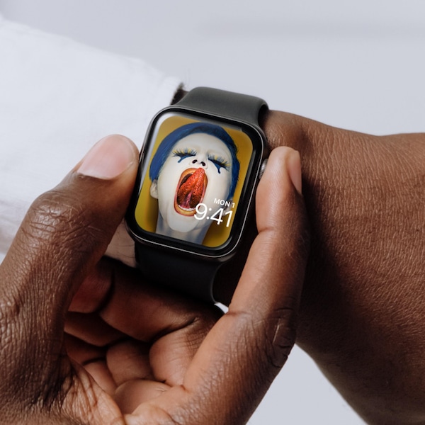 Man wearing Apple Watch with lock screen of blue haired woman licking lips with holed tongue from FX's AHS Cult