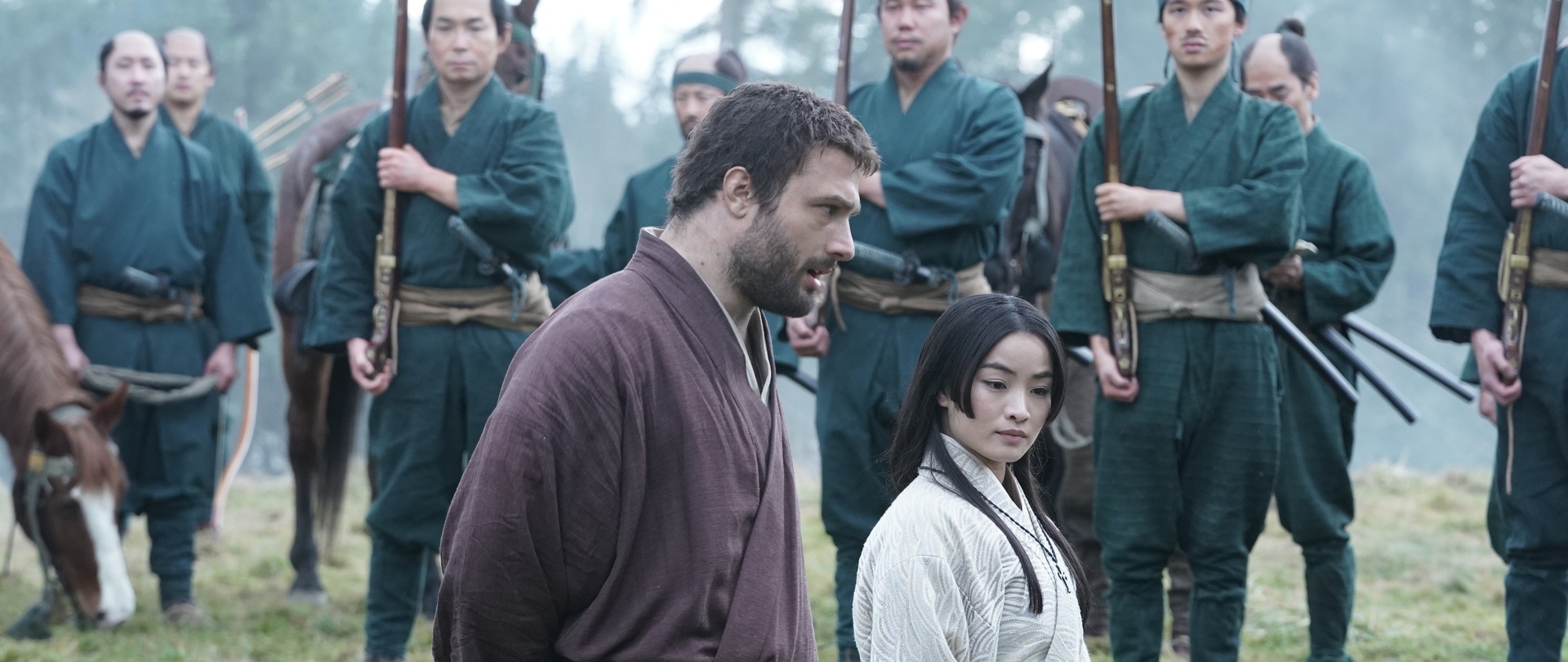 Blackthorne walks alongside Mariko with several samurai behind them