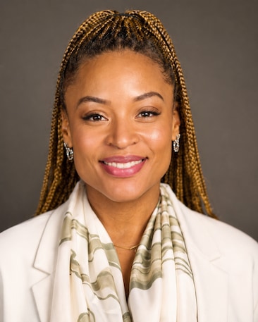 Crystle Roberson Dorsey headshot wearing a white suit and diamond earrings