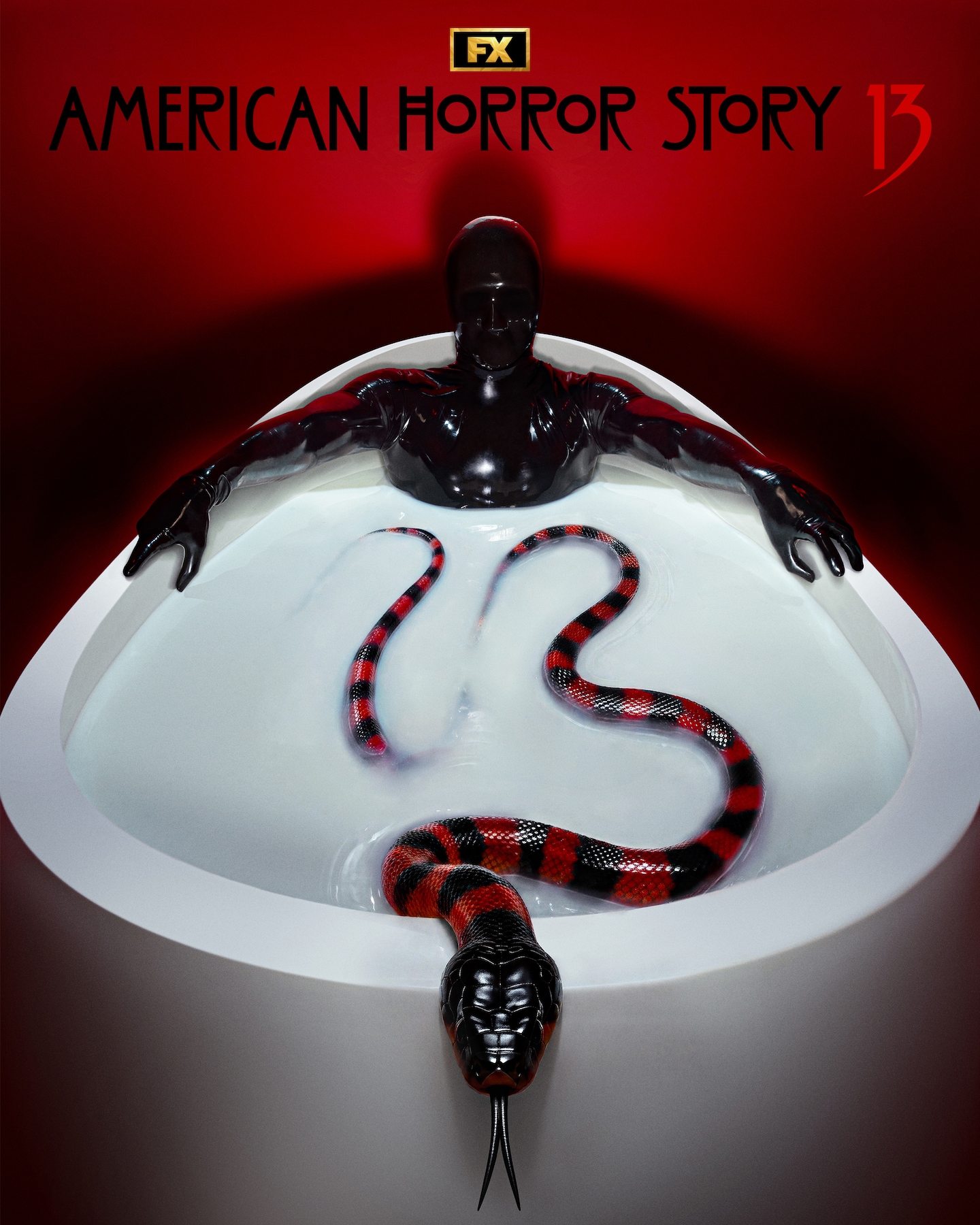 Rubber man in a white tub full of white liquid and a red and black snake contorted to spell "13" in a red room.