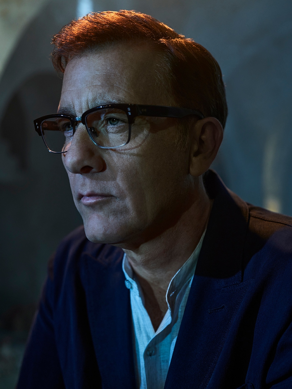 Man with glasses and blue suit. 