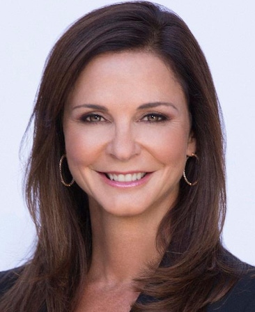 Nissa Diederich headshot wearing a black shirt and gold earrings