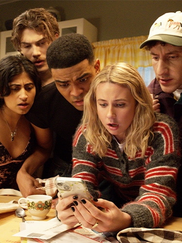 The cast of FX's Adults sitting on their couch in the living room.