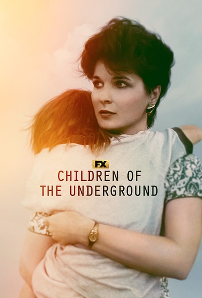 Faye Yager with short black hair wearing a floral dress carrying an older child for FX's Children of the Underground